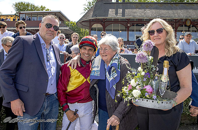 Ejer Lone Kaj-Nielsen og jockey Elione Chaves i vindercirklen for at modtage ærespræmie, udsat af Yvonne og Flemming Salomonsen, Falkonertjenesten. Foto Burt Seeger